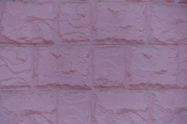 Close shot of painted pink masonry veneer wall