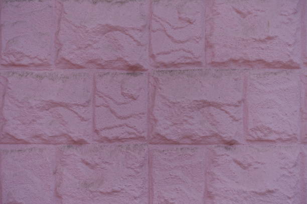 Closeup of painted pink masonry veneer wall