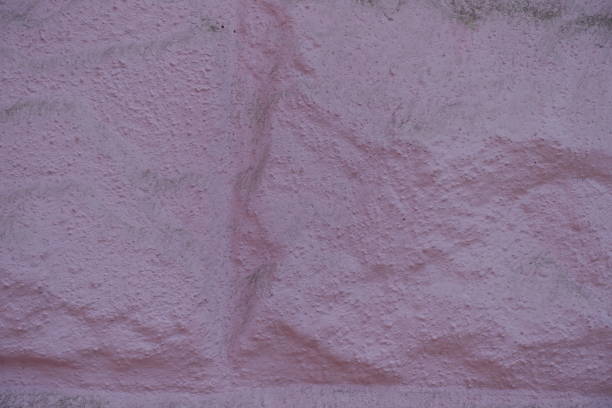 Macro of painted pink masonry veneer wall