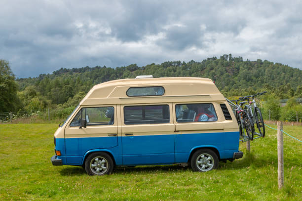 united Kingdom - July 19 2024: VW camper van parked in lush hilly countryside
