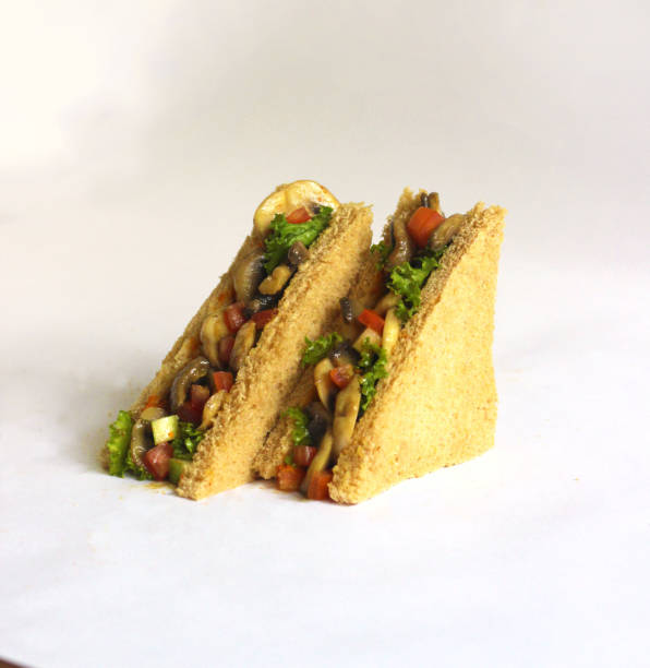 Mushroom sandwich in brown bread. barbeque spread healthy salad sandwich on brown bread with fresh greens, tomatoes, and lettuce.