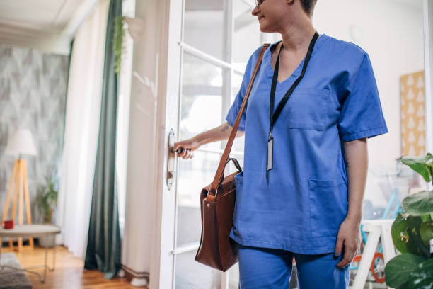 istock Individual in blue scrubs entering a cozy home 2163733063