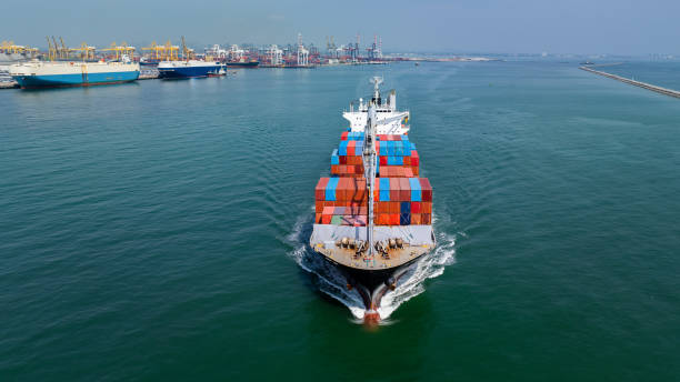 istock logistic cargo container ship sailing in sea import export goods and distributing products to dealer and consumers across worldwide, by container ship Transport business service 2163734667