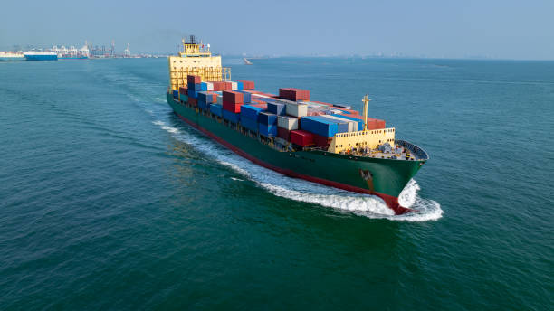 istock logistic cargo container ship sailing in sea import export goods and distributing products to dealer and consumers across worldwide, by container ship Transport business service 2163734668