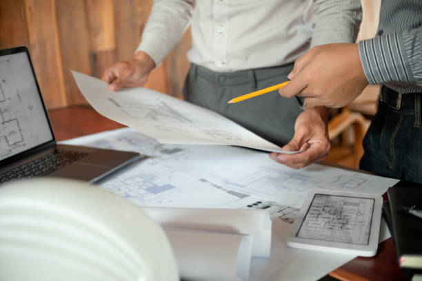istock Architects interior designer hands working with Blue prints and documents for a home renovationÂ for house design 2163734726