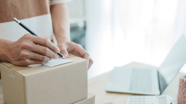 istock Business owner entrepreneur packing cardboard box preparing parcel for shipment, Online marketing. 2163734754