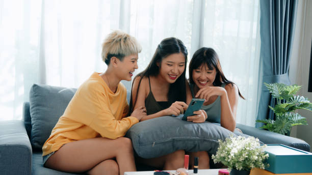 istock Three young women using a smartphone online shopping on the couch 2163735317