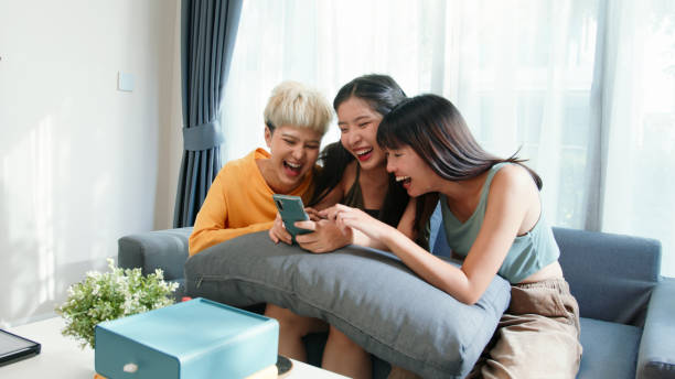 istock Three young women using a smartphone online shopping on the couch 2163735342