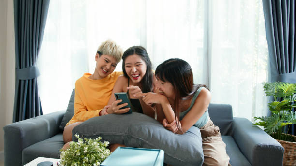 istock Three young Gen z women using a smartphone online shopping on the couch 2163735349