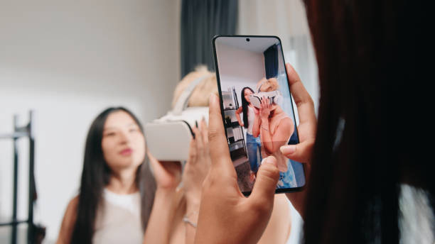 istock Female Friends capturing a VR experience on smartphone 2163735368