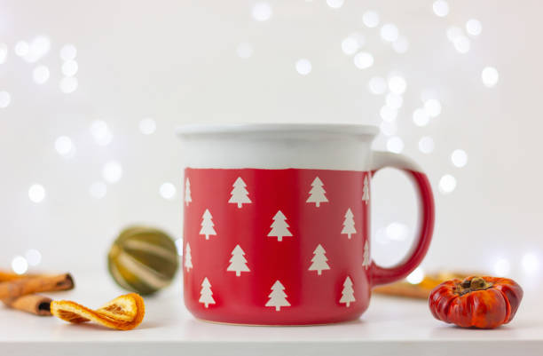 istock red cup with white fir trees on a table with dry lemon and cinnamon. celebration, winter holiday 2163736005