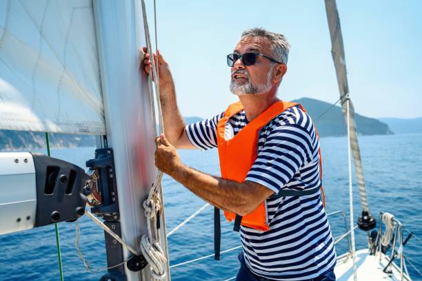 istock Mature man on sailboat 2163736237