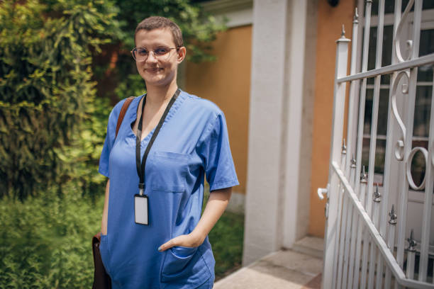 istock Nurse in scrubs standing outdoors with ID badge visible 2163736254