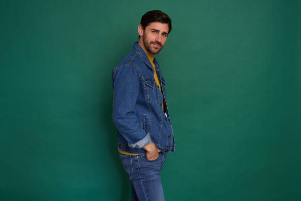 Handsome man posing with hand in pocket, looking confident and relaxed
