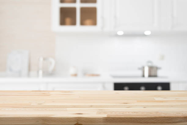istock Wooden table top on white and bright modern kitchen interior background 2163737527