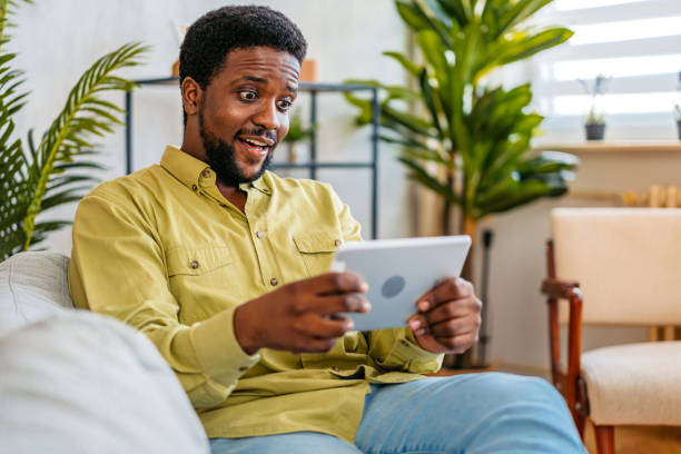 istock Young Man Watching Something On The Digital Tablet At Home 2163737831