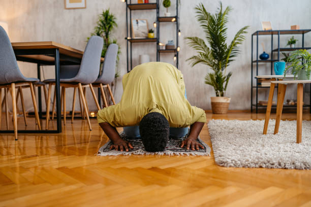 istock Young Black Muslim Man Praying At Home 2163738066