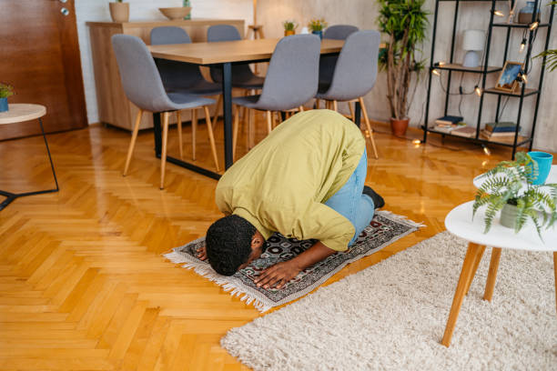 istock Young Black Muslim Man Praying At Home 2163738179