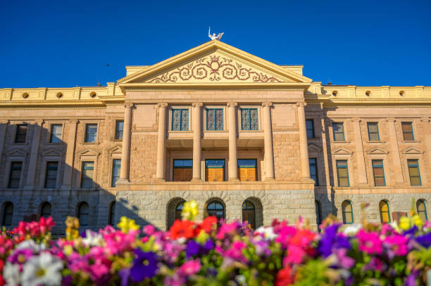 Arizona State Capitol in Phoenix, AZ, with colorful flowers in the foreground Arizona State Capitol in Phoenix, AZ, with colorful flowers in the foreground under a blue sky. It was the last home for Arizona's territorial government until Arizona became a state in 1912. phoenix stone stock pictures, royalty-free photos & images