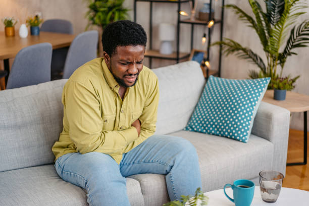 Young Man Having Stomachache At Home
