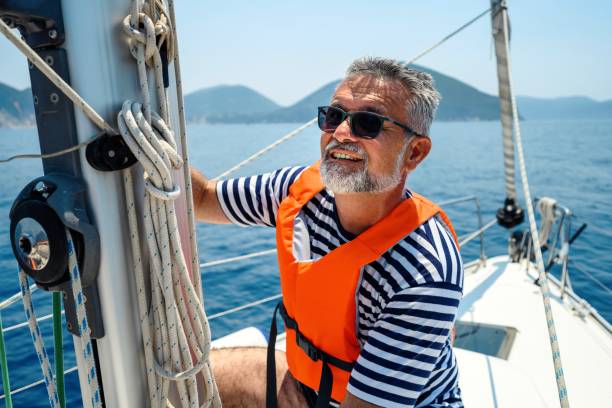 istock Mature man on sailboat 2163739900
