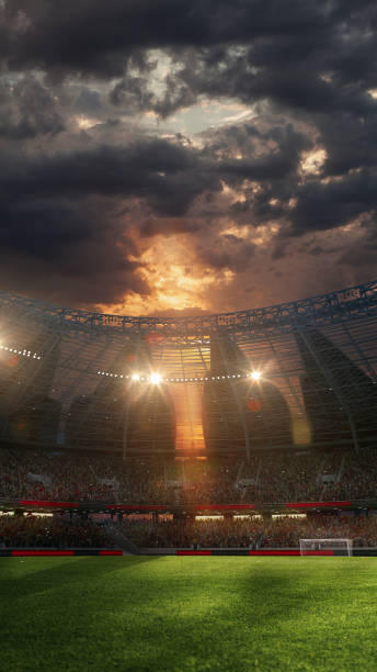 istock Vertical image of 3D render of soccer stadium under dramatic sky during sunset time. filled tribunes of fans. Opening season of games. 2163740089