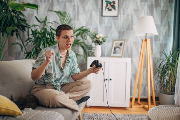 istock Person thrilled while gaming on a sofa with green plants 2163740424