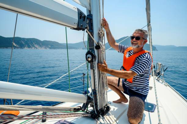 istock Mature man on sailboat 2163741493