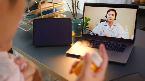 istock Asian Father using telemedicine while holding baby 2163741682