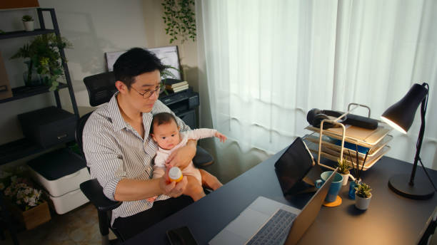istock Asian Father using telemedicine while holding baby 2163741691