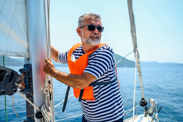 istock Mature man on sailboat 2163743608