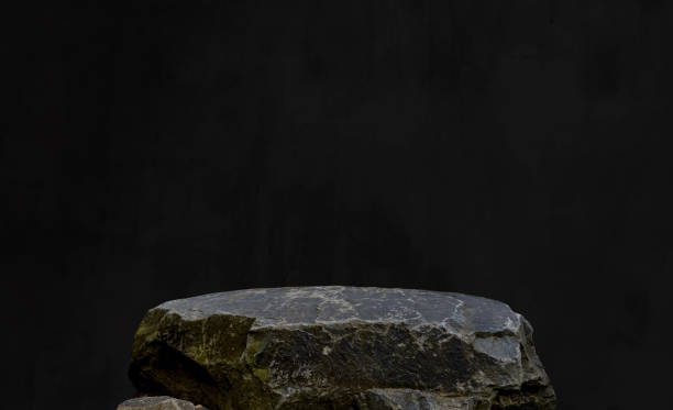 istock Stone Rock Podium with Black Background,Interior Studio Room Concrete Wall with light,Shadow on Rock cliff Display stage,Minimal template mockup for Jewelry Stand Product Present,Fashion branding 2163743940
