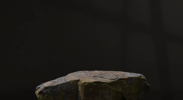 istock Black Background with Stone Rock podium isolated for product display presentation,Studio Background with Grey Sea Rock Stage with rough surface texture with light, shadow on dark concrete background 2163743950