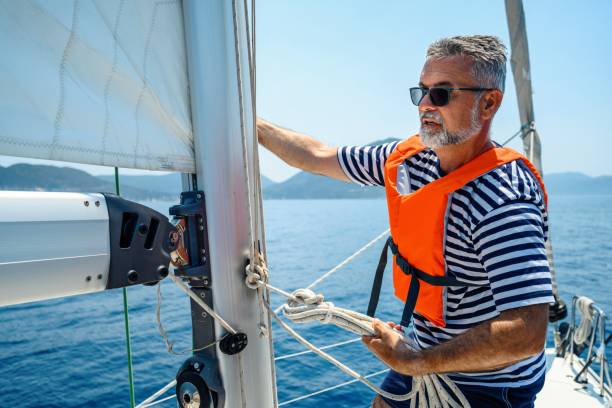 istock Mature man on sailboat 2163743994