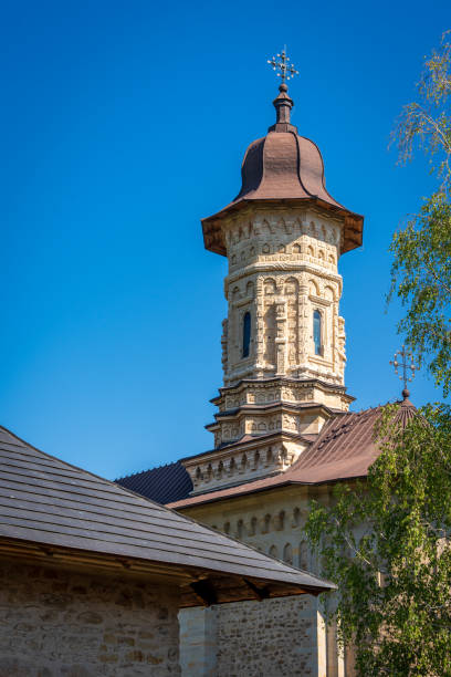 istock Historic Stone Tower of a Monastery Against Clear Blue Sky 2163744411