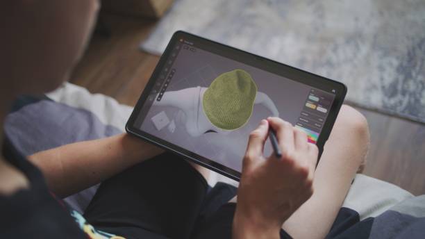 istock Boy with digital stylus and tablet in hands sits at home 2163744545