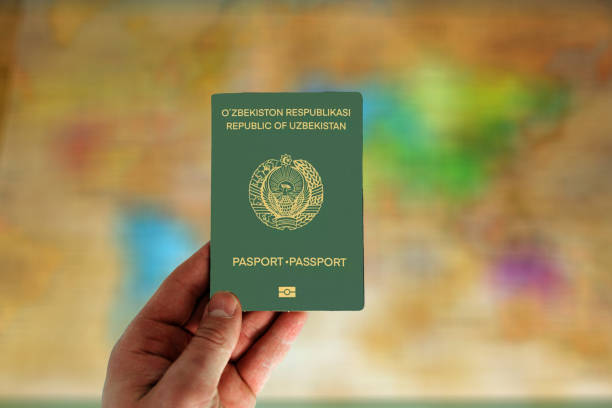 istock Uzbekistan passport in man hand 2163745778