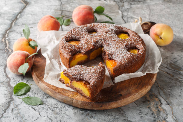 istock Fruit chocolate peach sponge cake summer dessert close-up on wooden board. Horizontal 2163745979