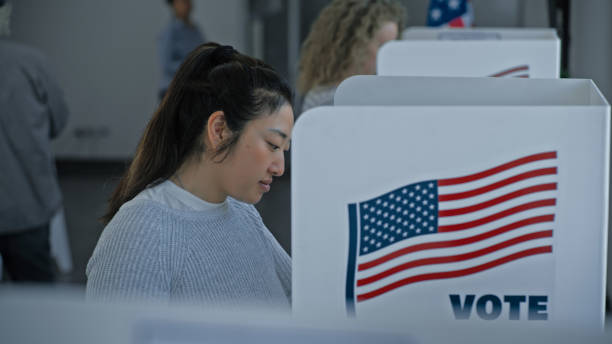 istock Multicultural American citizens come to voting booth 2163748272