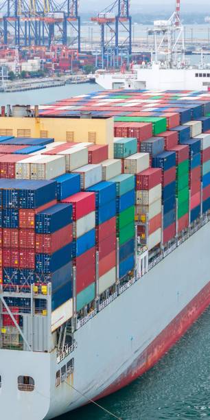 istock Portrait view Cargo container ship carrying container and running in international container port customs shipyard sea port concept smart logistic service. stern Container Ship 2163749849