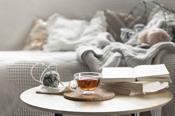 istock Cozy composition with a cup of tea, a candle and knitted elements. 2163750996