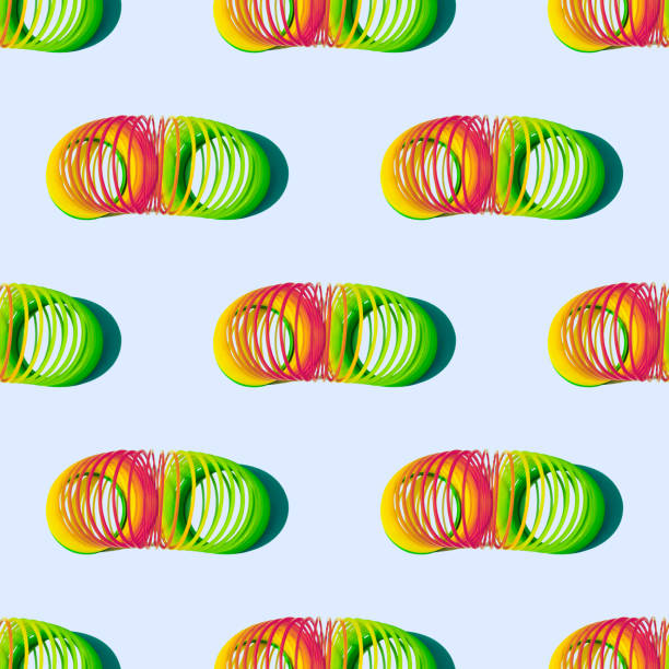 Plastic multicolored spiral toys on colored background