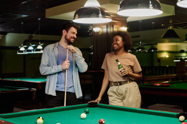 istock Couple chatting after game of billiards 2163752876