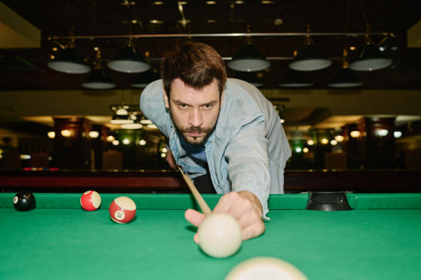 istock Man hitting billiard ball with cue 2163752890