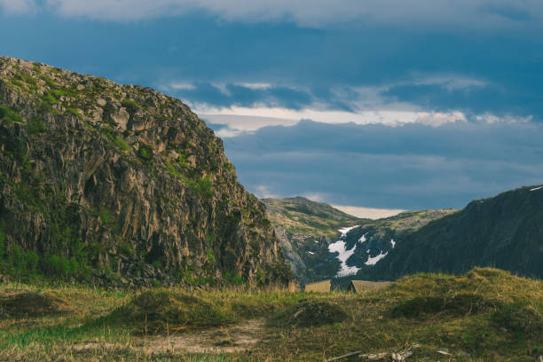 Majestic Mountainous Landscape with Dramatic Cloudy Sky and Lush Greenery