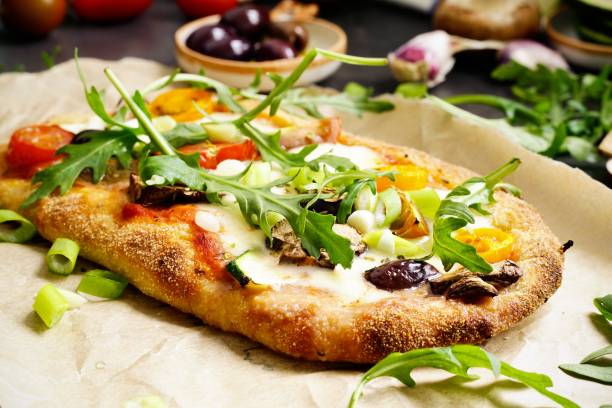 istock Homemade Pinsa with tomato, olive, arugula and mozzarella 2163757796