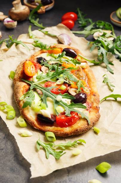 istock Homemade Pinsa with tomato, olive, arugula and mozzarella 2163757816