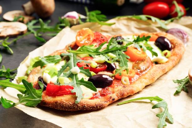 istock Homemade Pinsa with tomato, olive, arugula and mozzarella 2163757835