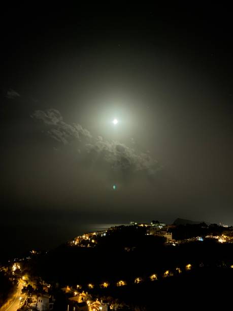 istock The moon breaks through the clouds, night, black sky, moody sky 2163759096