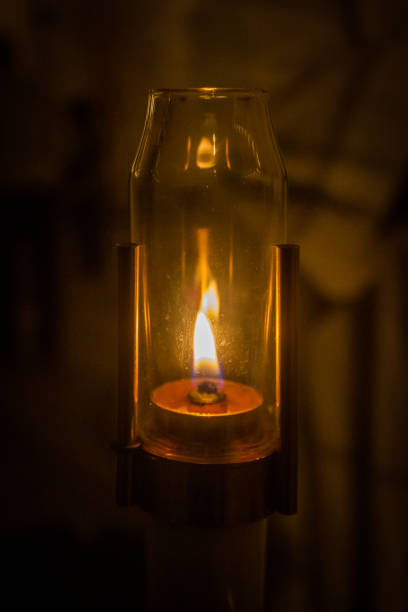 a burning candle in the dark at a regional celebration